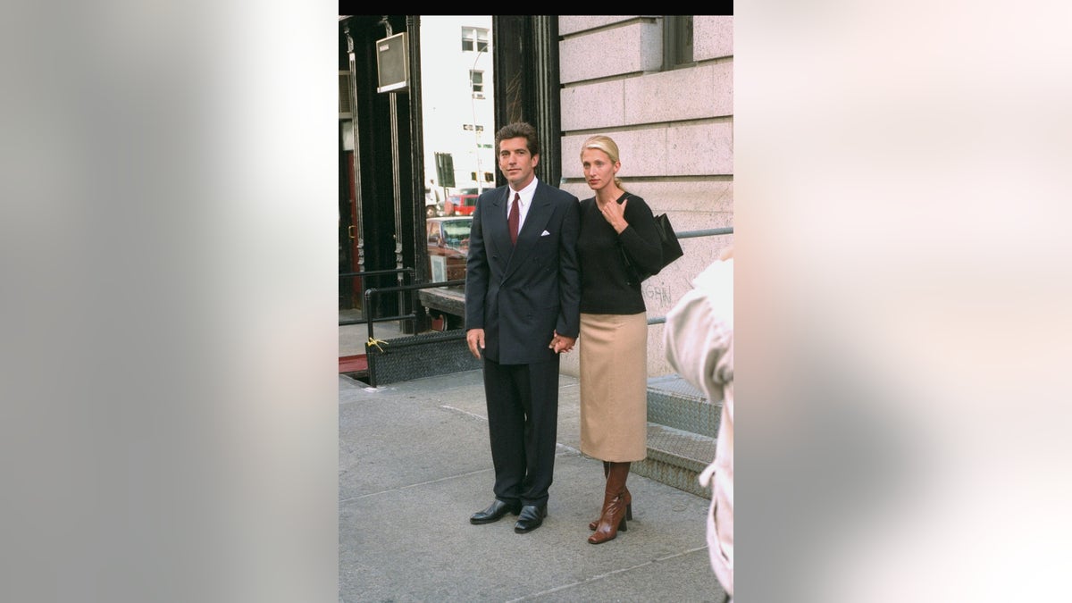 Carolyn Bessette-Kennedy walking outside with John F. Kennedy Jr.