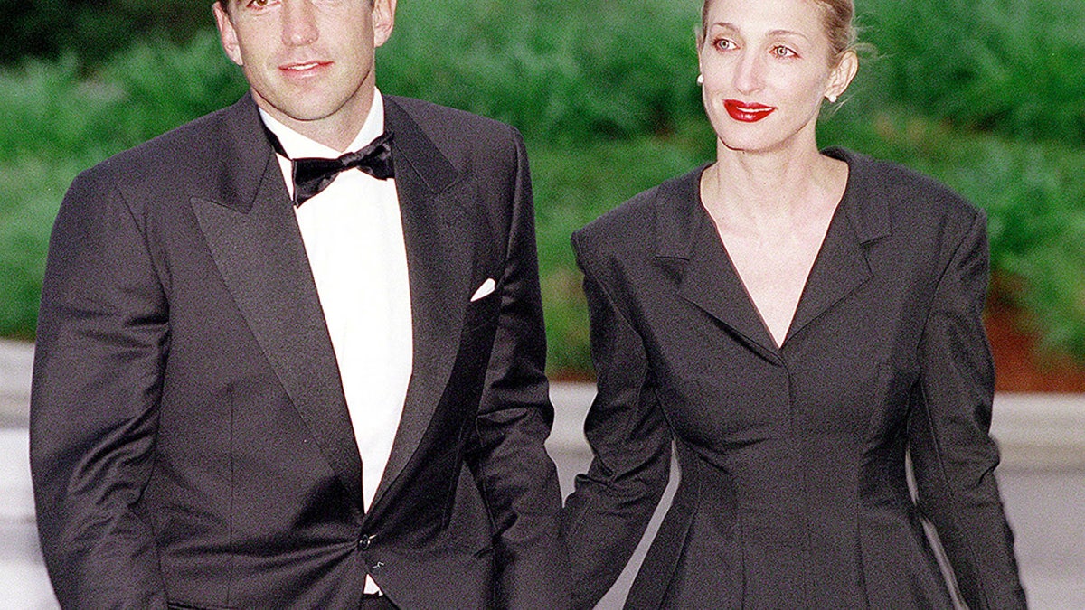 JFK Jr. and Carolyn Bessette-Kennedy holding hands in public.