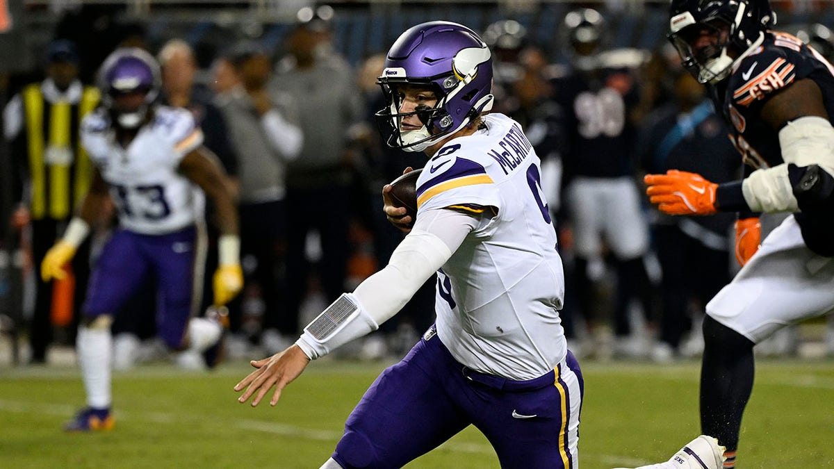 JJ McCarthy runs with the ball