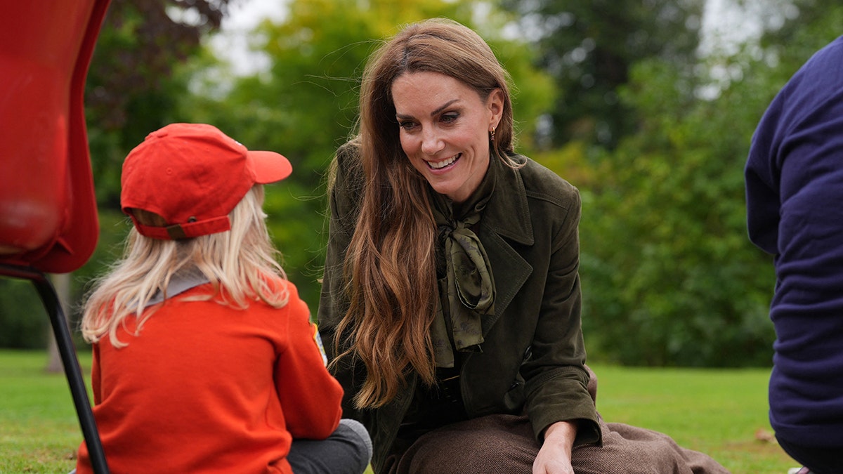 Kate Middleton speaking to a child at Windsor.
