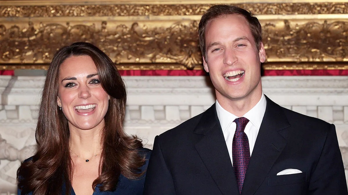 Prince William and Kate Middleton smiling in formal wear after announcing their engagement.