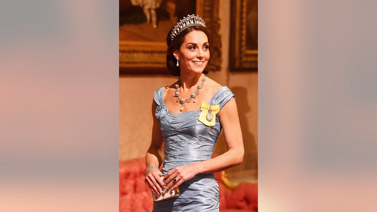 凱特·米德爾頓(Kate Middleton)穿著淡藍色連衣裙,帶有珠寶和頭飾。