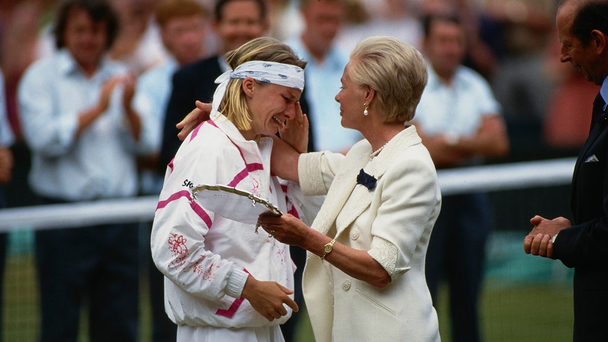 British Royal Katharine, Duchess of Kent, comforts tennis player