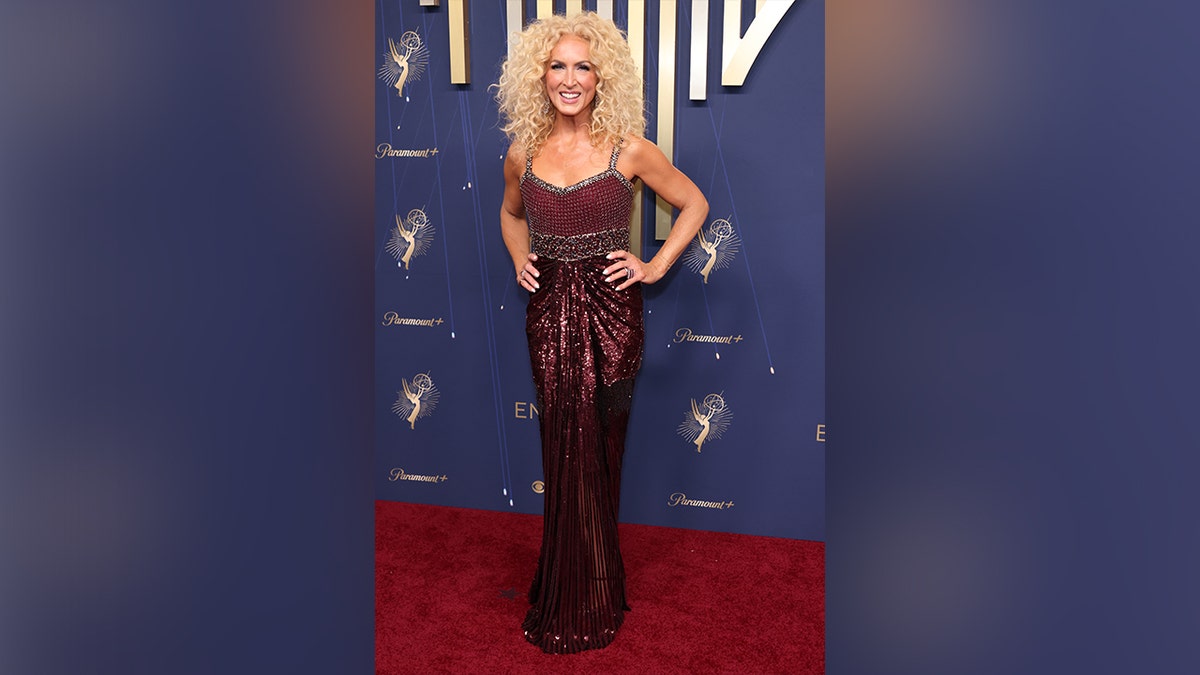 Kimberly Schlapman at the 2025 Emmy Awards in a red dress.