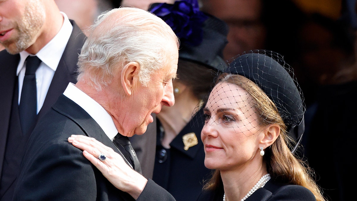 Kate Middleton bowing to King Charles.