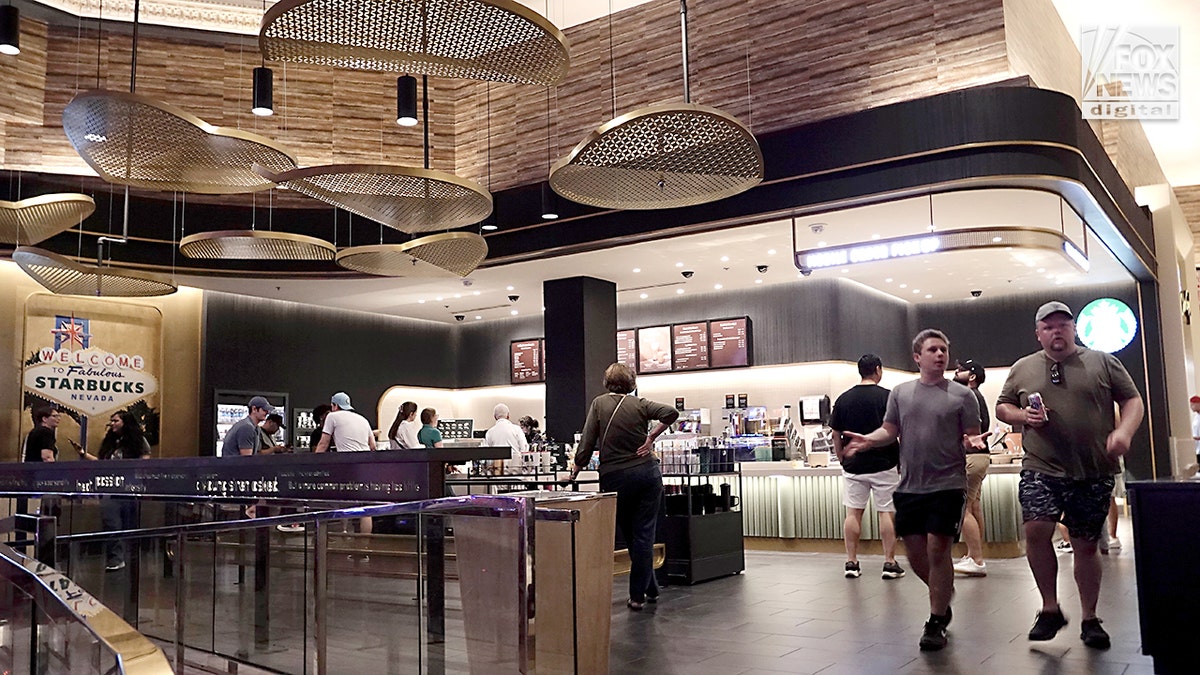 Guests sitting and standing inside a Starbucks at a hotel in Las Vegas