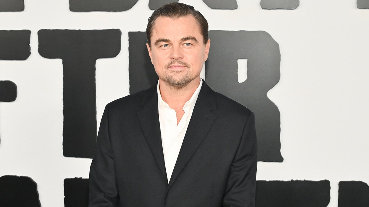 Leonardo DiCaprio on the red carpet in a suit at the premiere of "One Battle After Another" in September 2025.