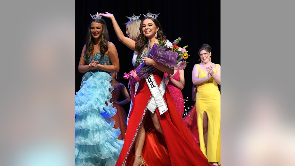 Alexia Rodrigues walking with her flowers and crown after winning Miss Rhode Island.