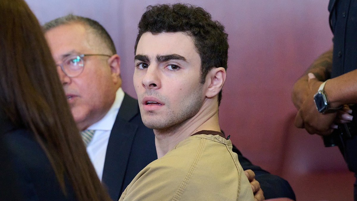 Luigi Mangione seated successful  tribunal  arsenic  justice  drops coercion  charges.