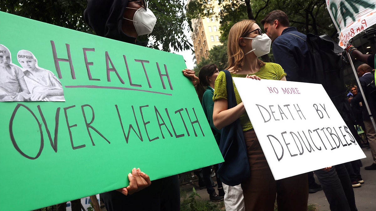 Supporters of Luigi Mangione hold signs