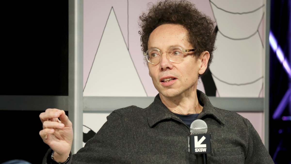 Malcolm Gladwell speaks on stage