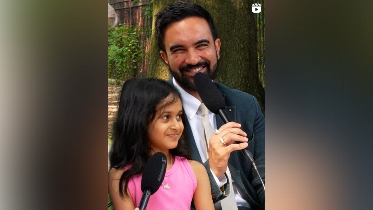 Mamdani talks with a little girl