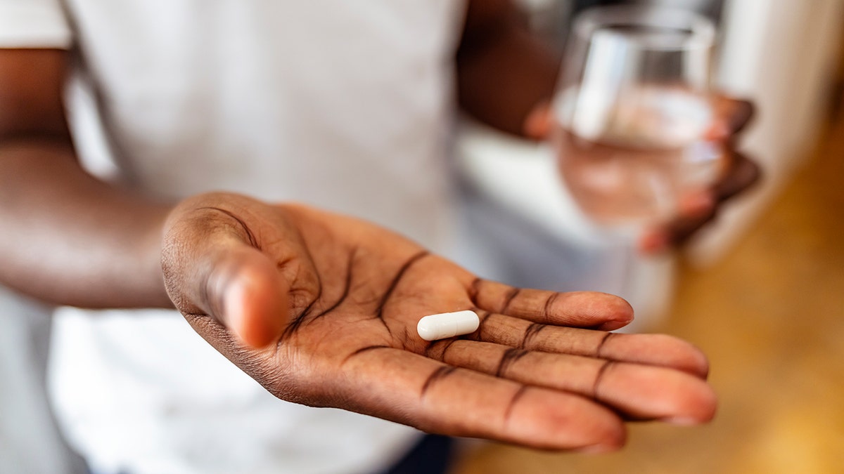 man taking a pill