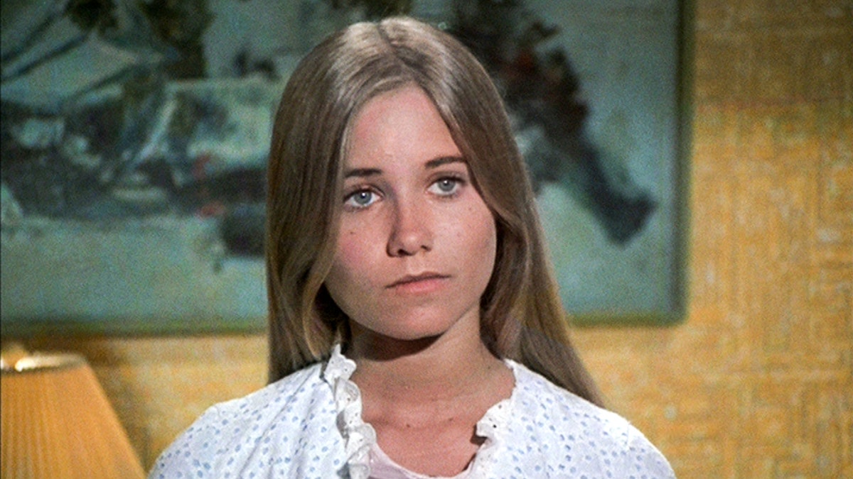 Maureen McCormick as Marcia Brady looking pensive.
