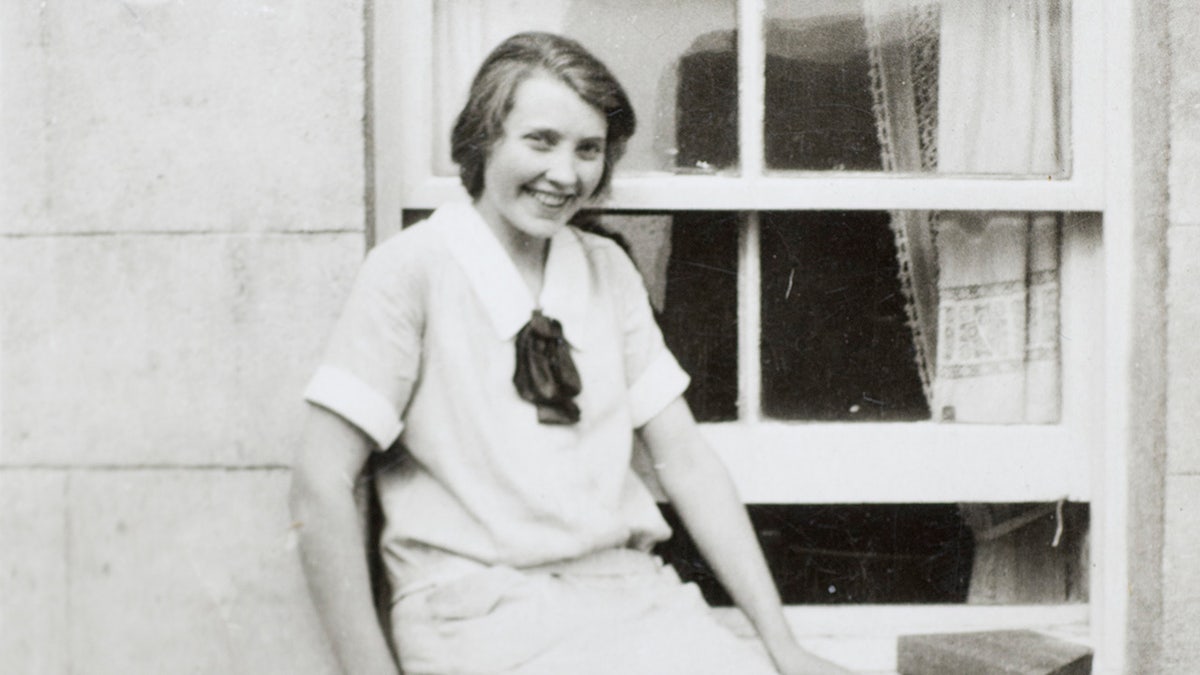 A black and white photo of a young Mary Trump smiling in Scotland.