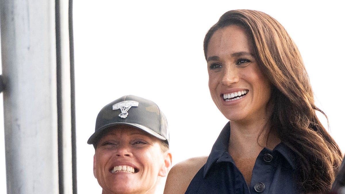 Meghan Markle smiling at a Kevin Costner event