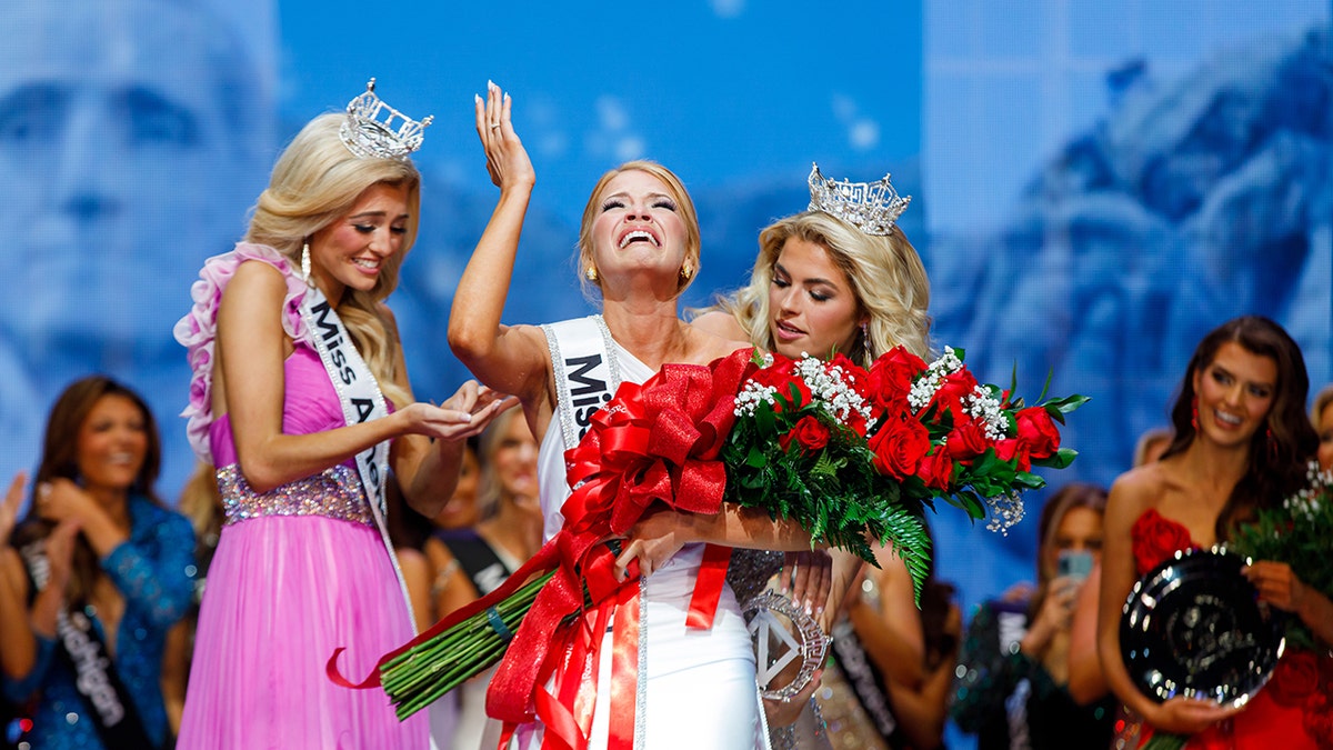 Miss America looking up and crying after winning.