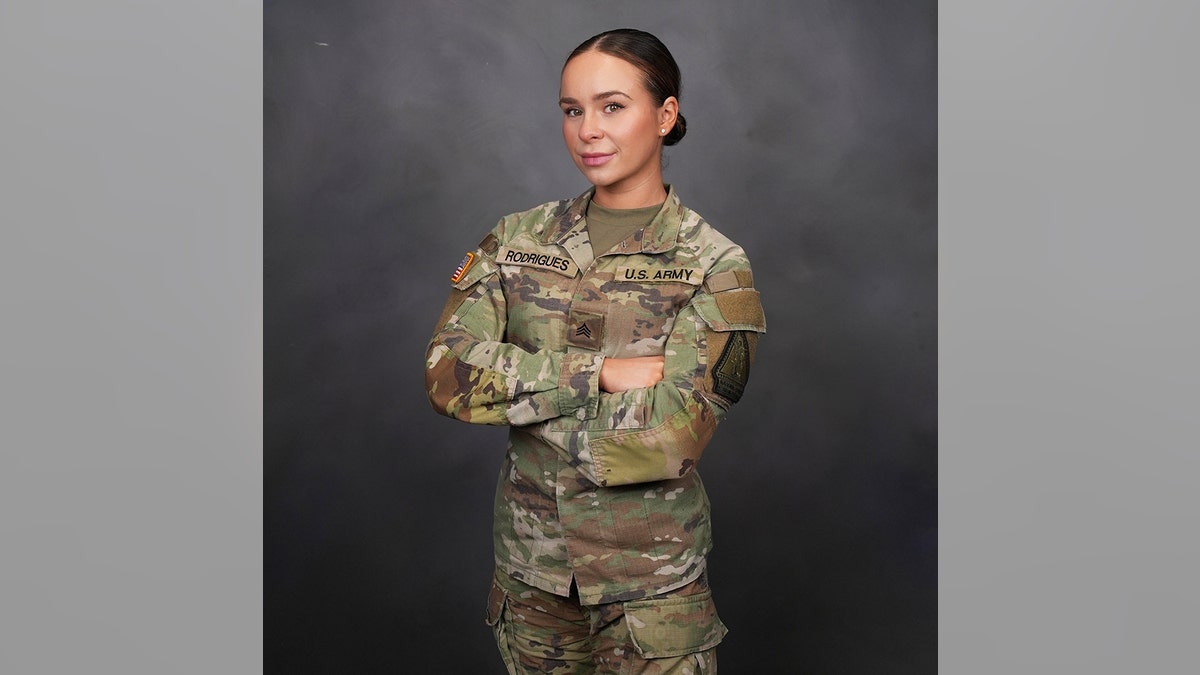 Alexia Rodrigues with her arms crossed as a soldier in Army National Guard.