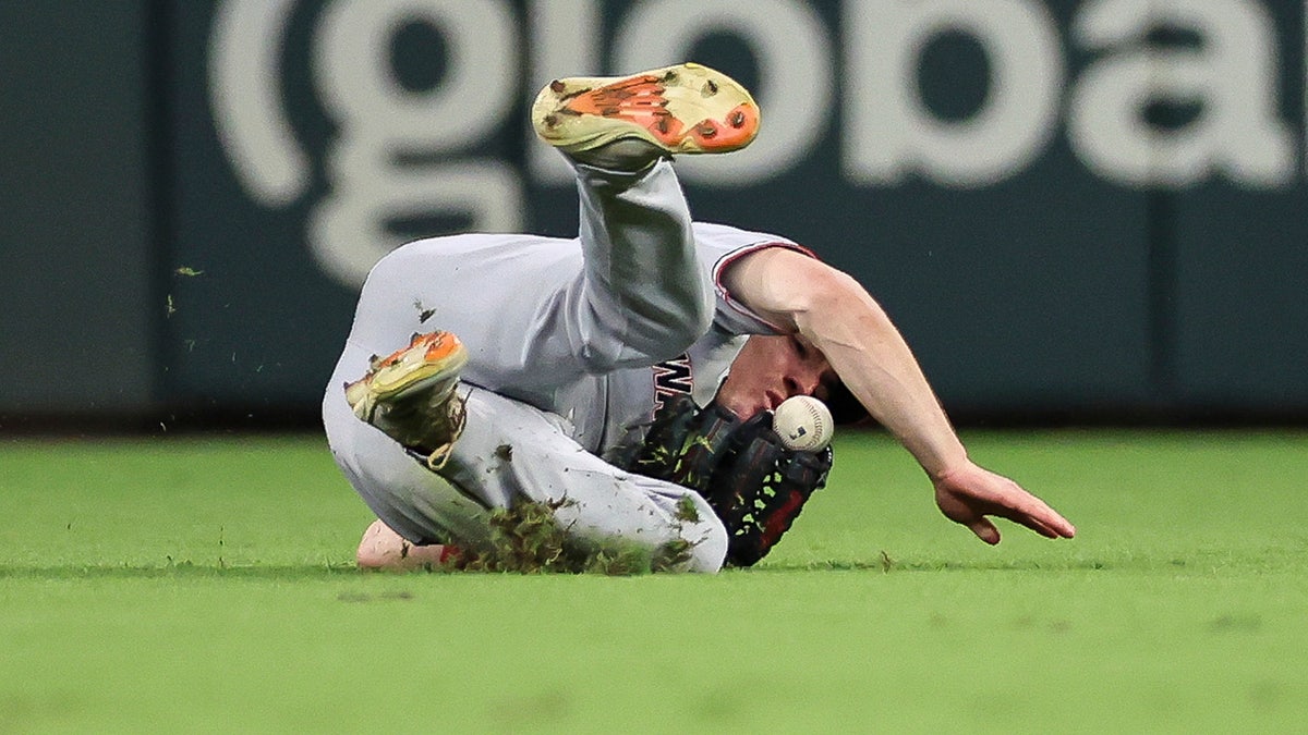 Jacob Young tracks a deep fly ball toward the warning track