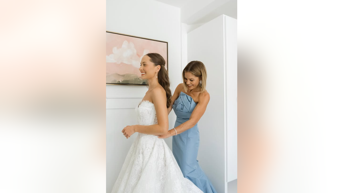 Candace Cameron Bure zips up her daughter Natasha's wedding gown.