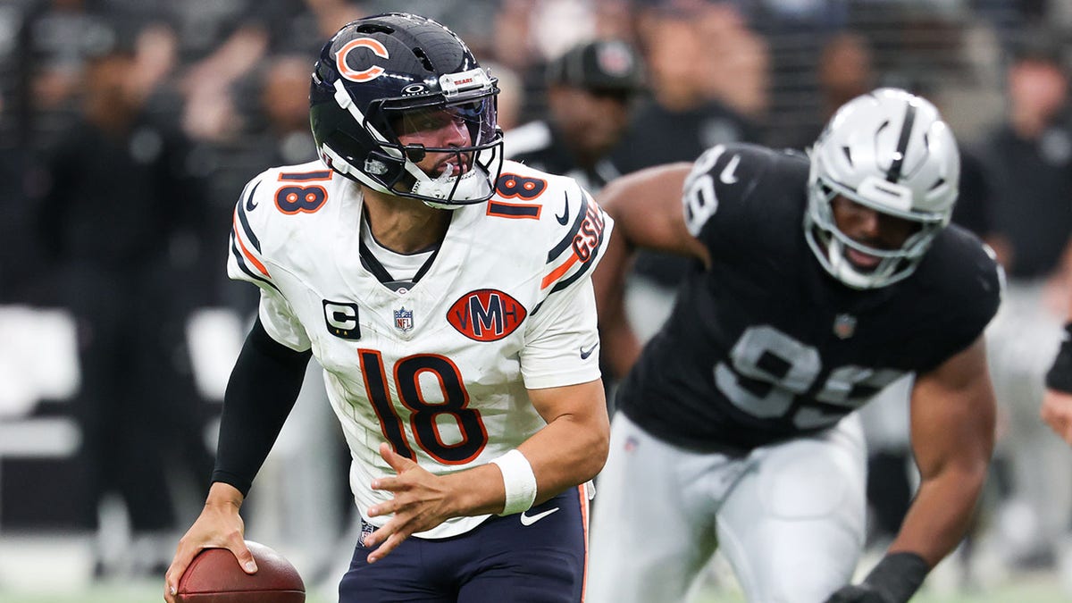 Caleb Williams looks to pass