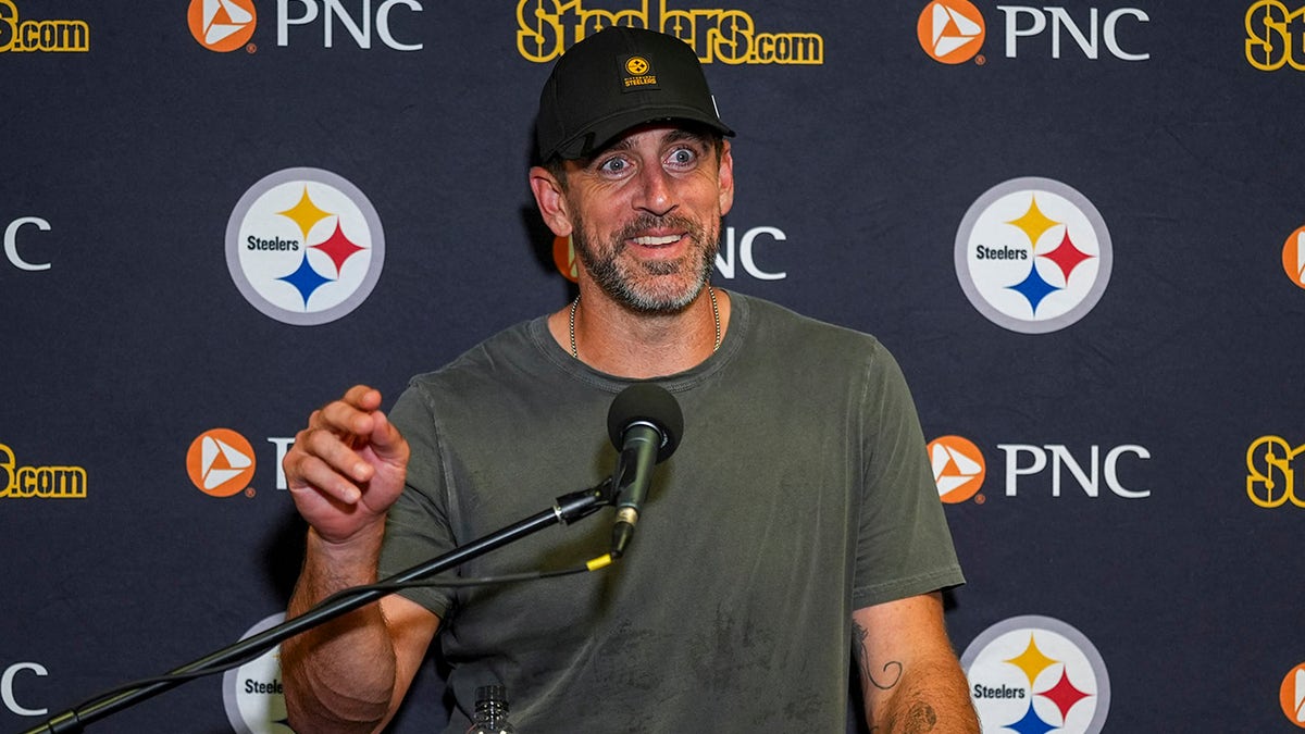 Aaron Rodgers talks to reporters