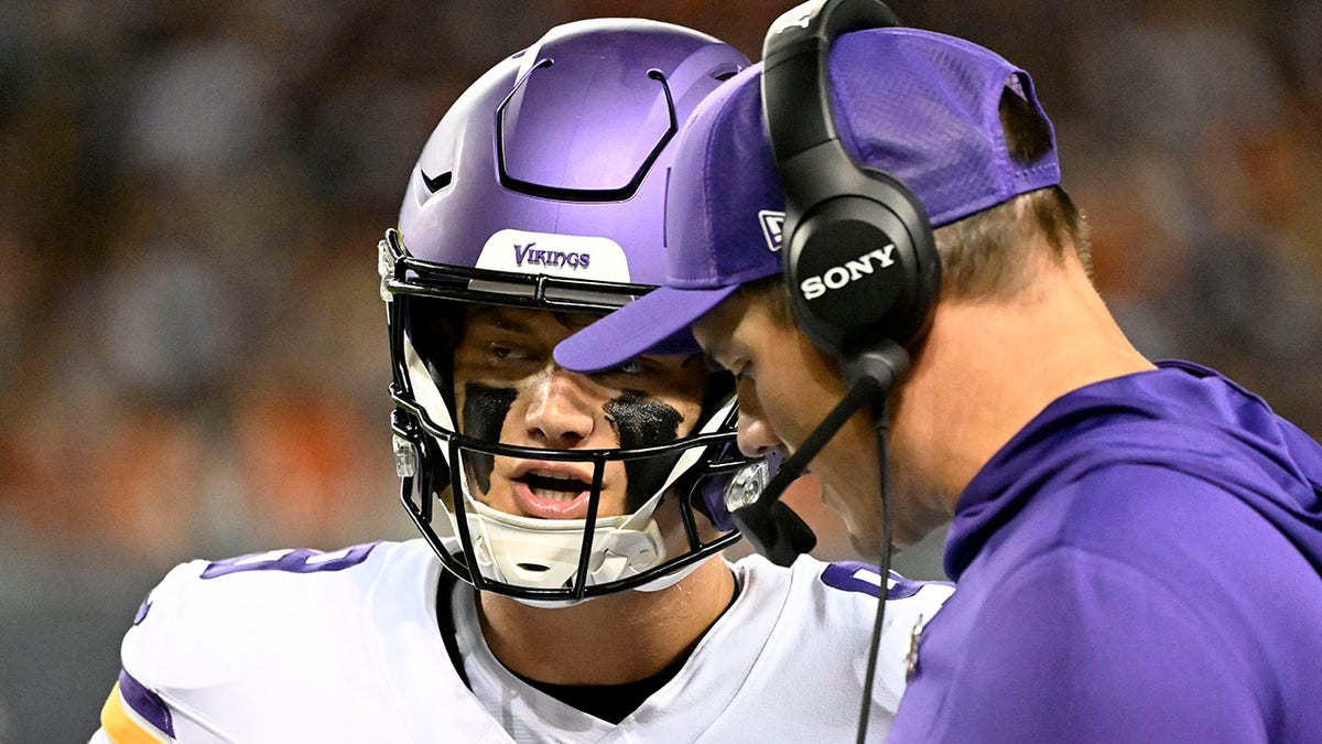 JJ McCarthy talks to coach