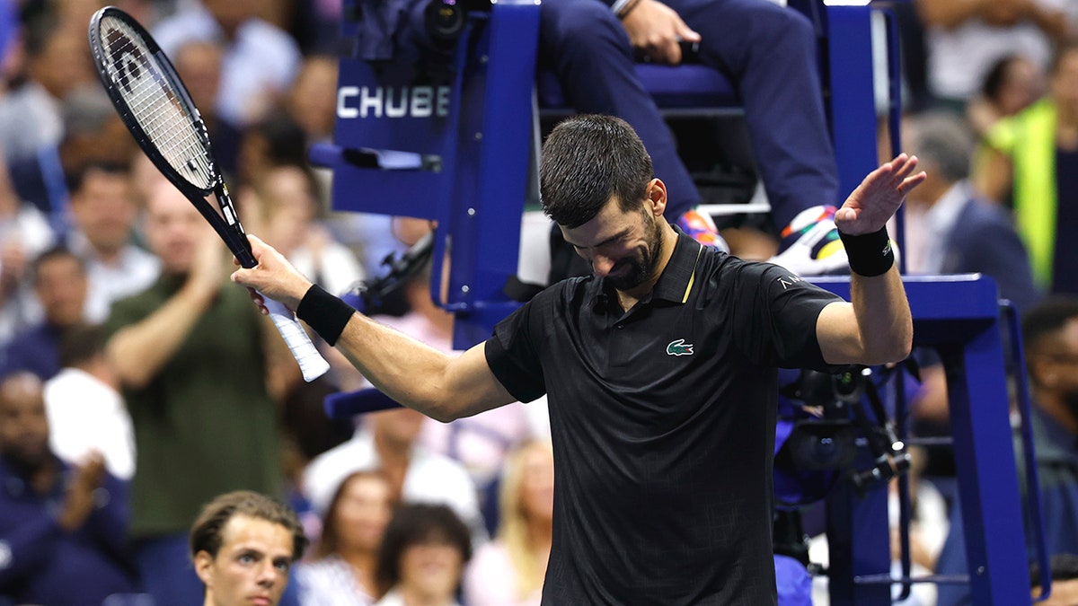Novak Djokovic gestures to the crowd