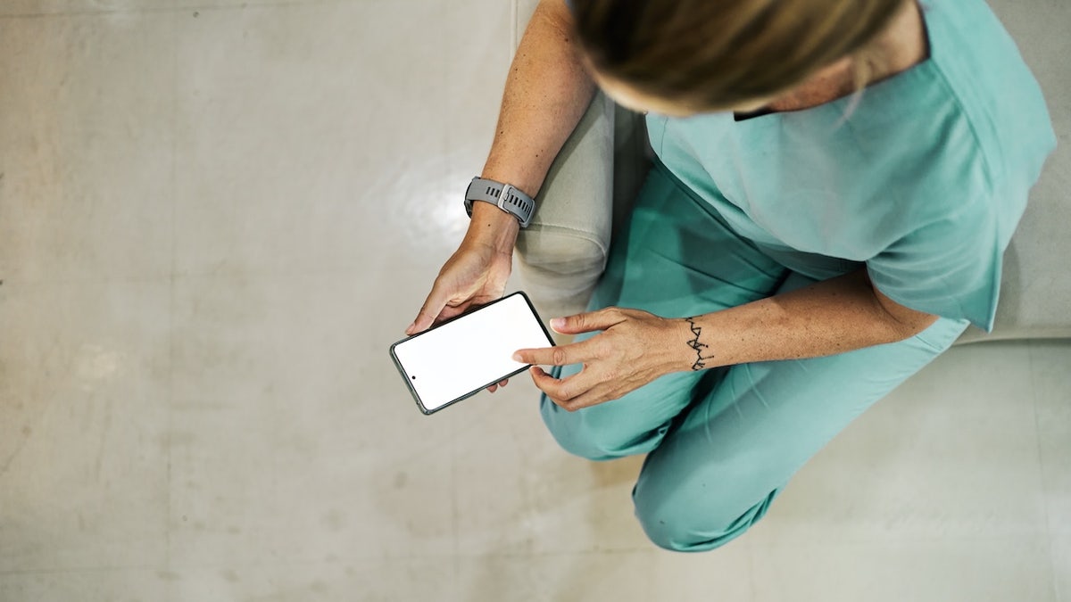 Nurse scrolling on phone