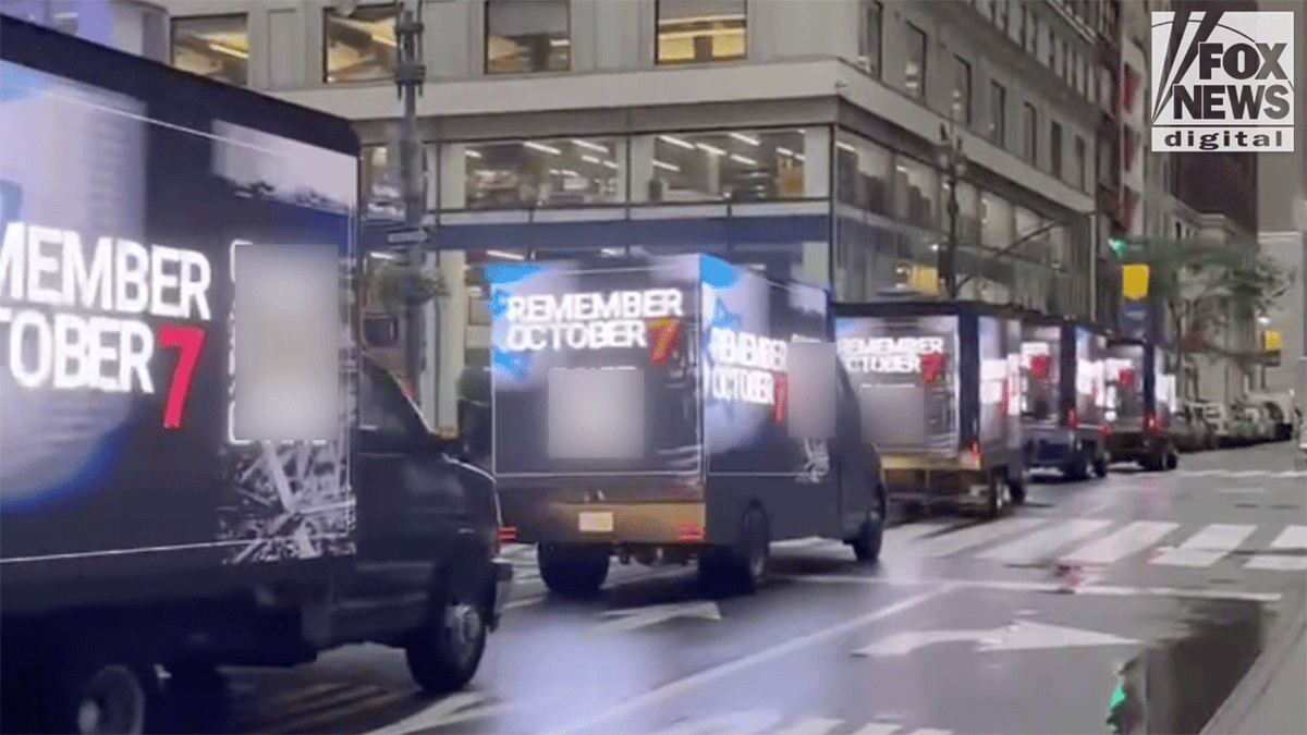 October 7 campaign trucks driving down the street in New York