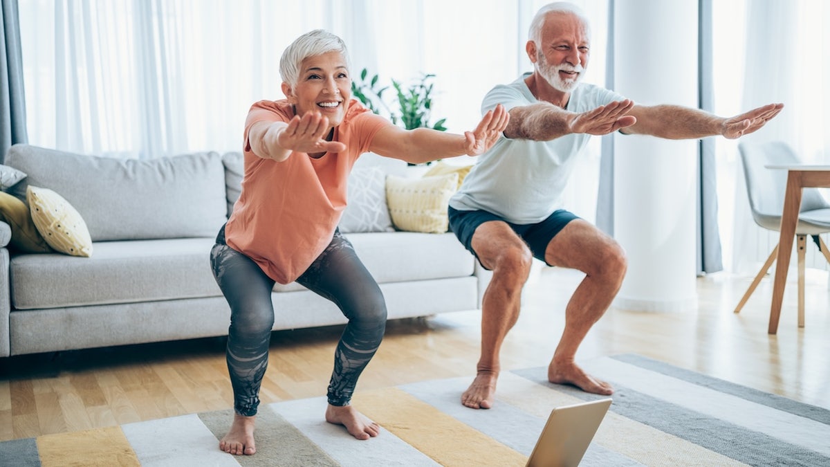 Elderly couple squatting down