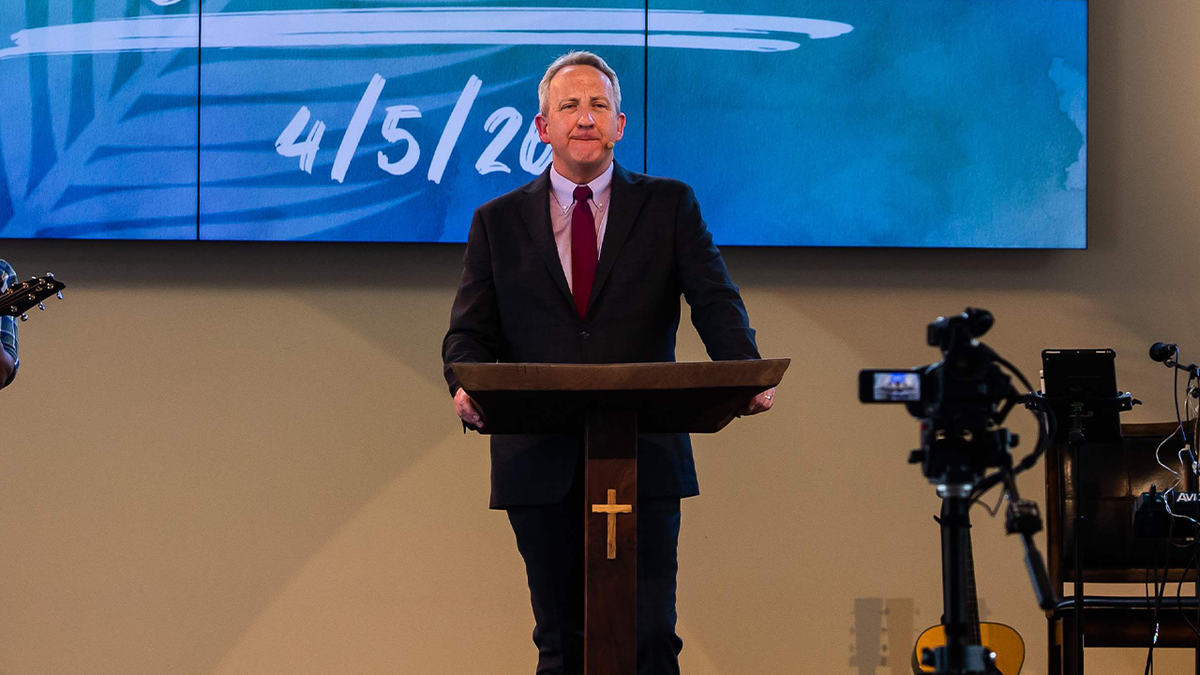 Pastor McCory speaks during religious service 