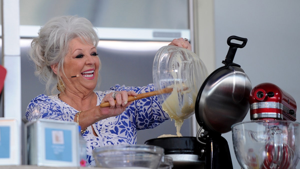 Paula Deen uses a mixer at a cooking event