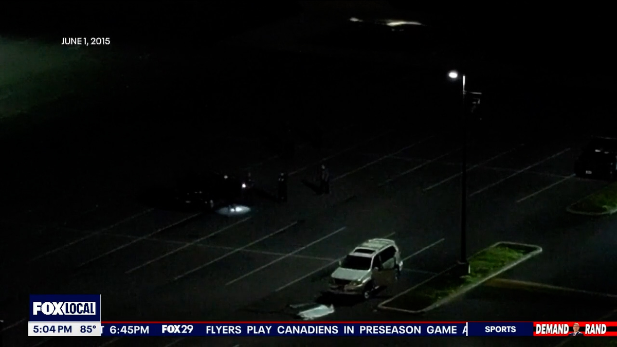 an aerial image shows police searching the parking lot after a car stunt left a teen dead