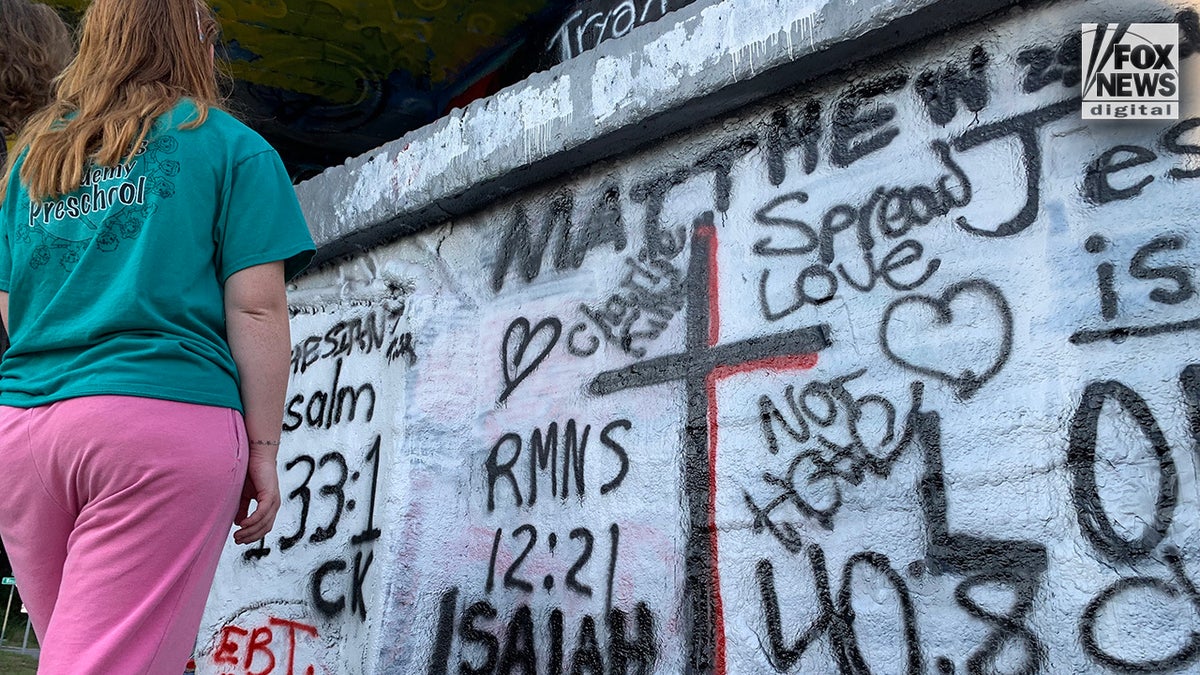 People write positive faith-filled messages over defaced Charlie Kirk mural