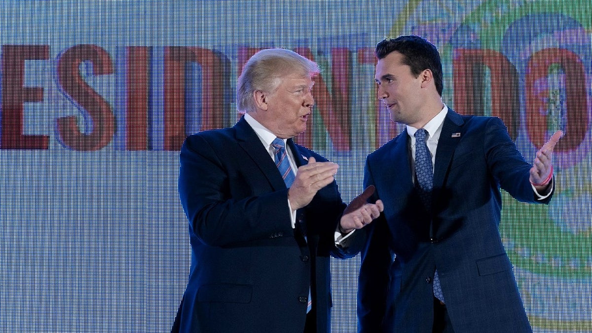 charlie kirk and donald trump durign rally smiling
