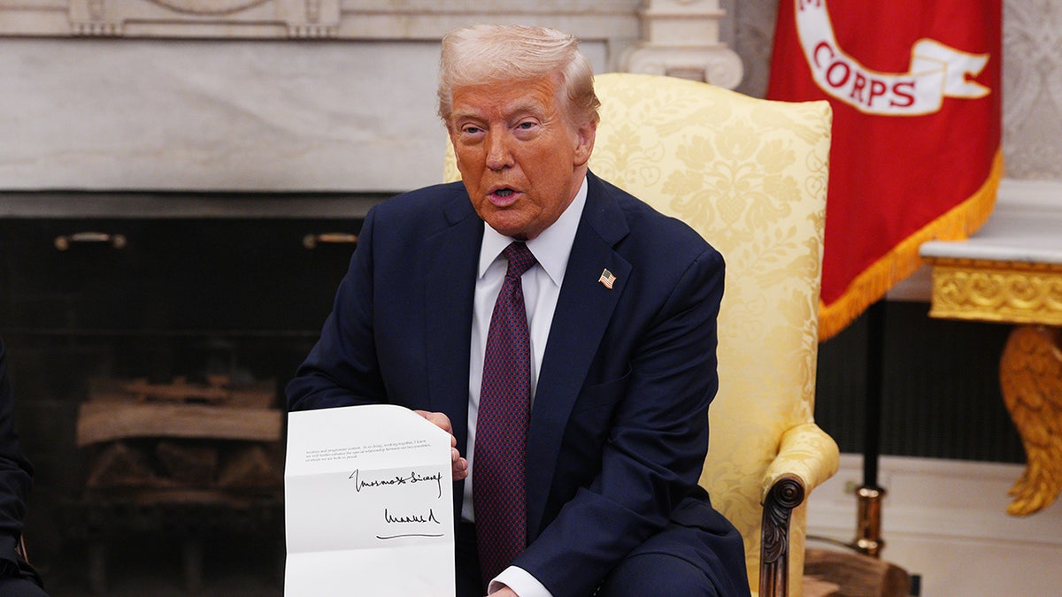 President Trump holding a letter from King Charles.