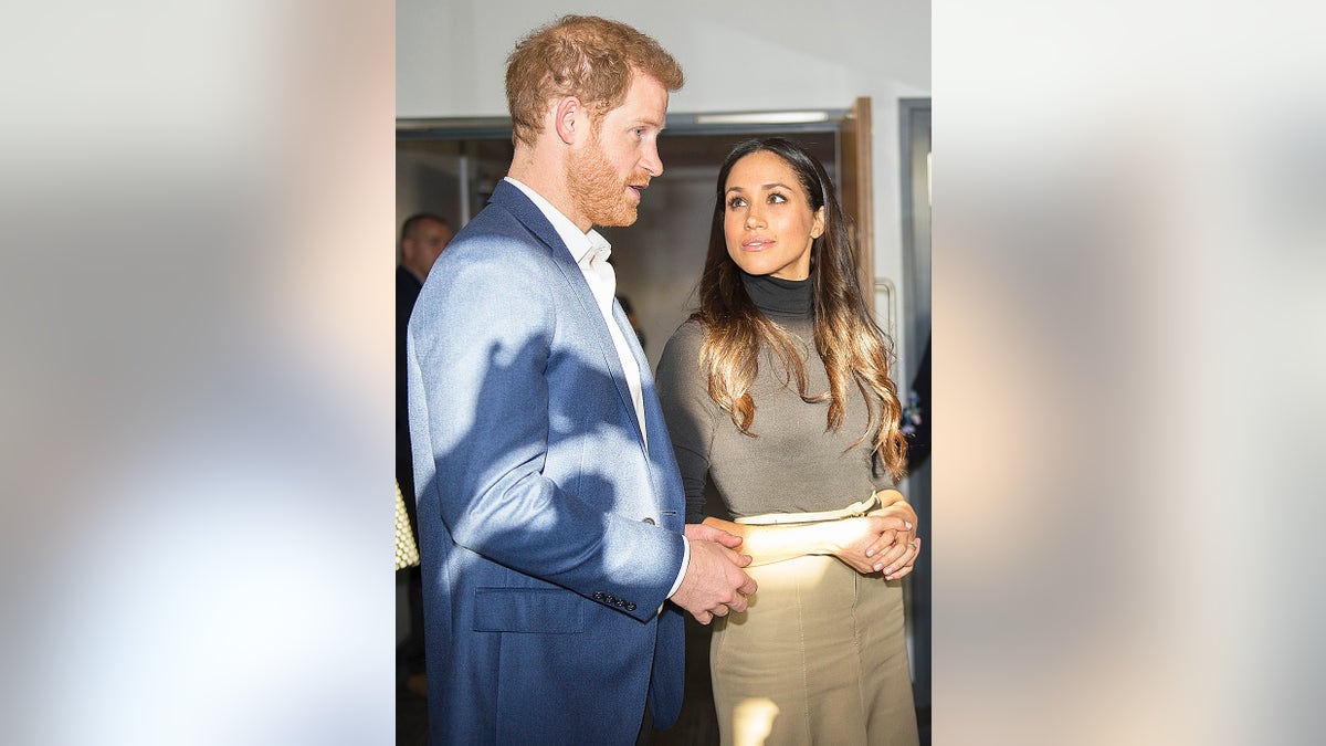 Meghan Markle looking up at Prince Harry.