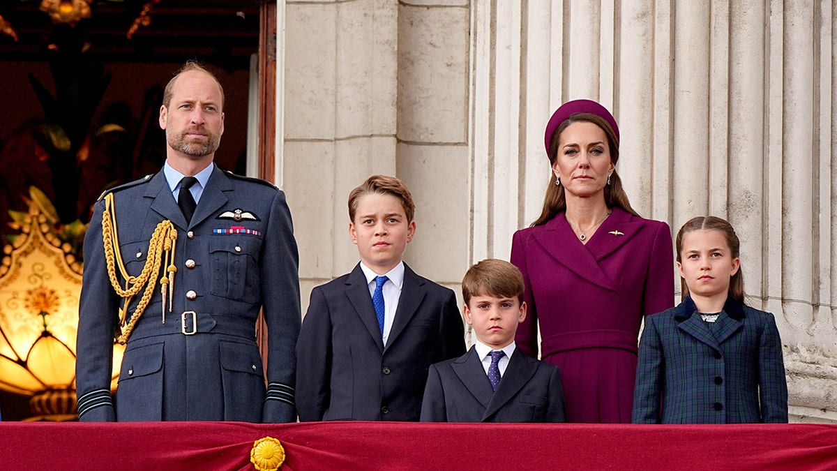 Prince William, Kate Middleton and their three children standing on the balcony of Buckingham Palace during a royal engagement.