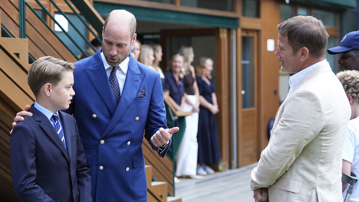Prince William instructing Prince George during a royal engagement.