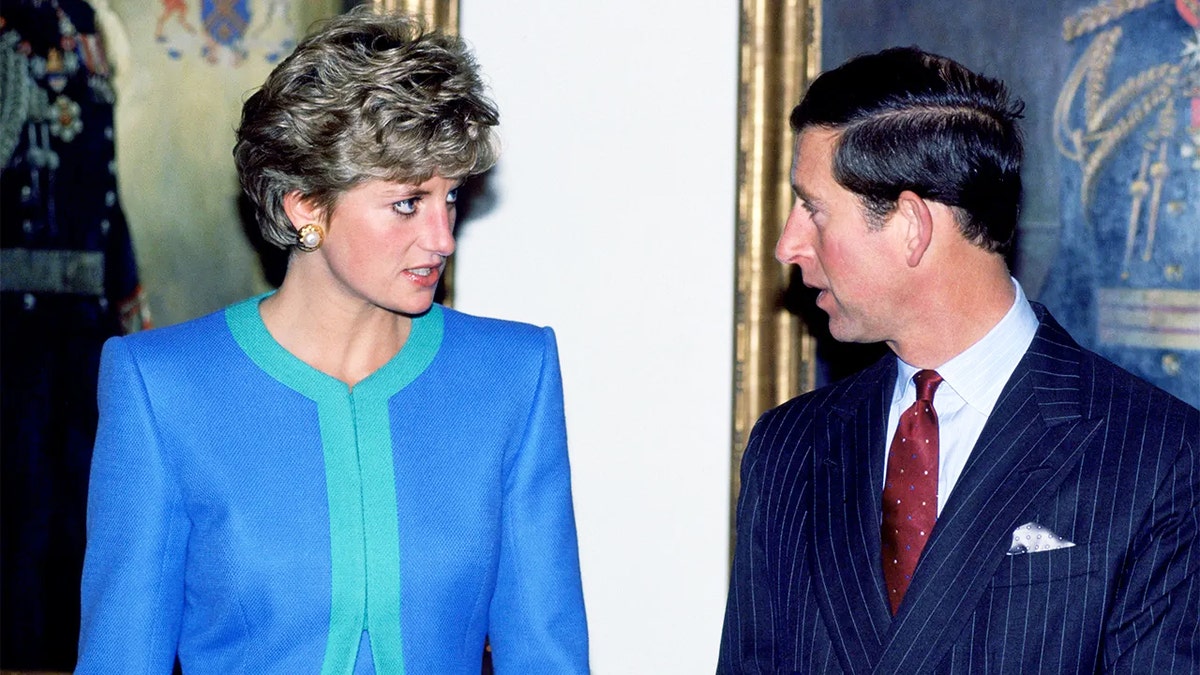 Princess Diana and Prince Charles appearing to have a tense conversation.