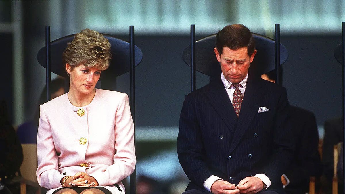 Princess Diana looks downcast as Prince Charles keeps his head down during a royal outing.