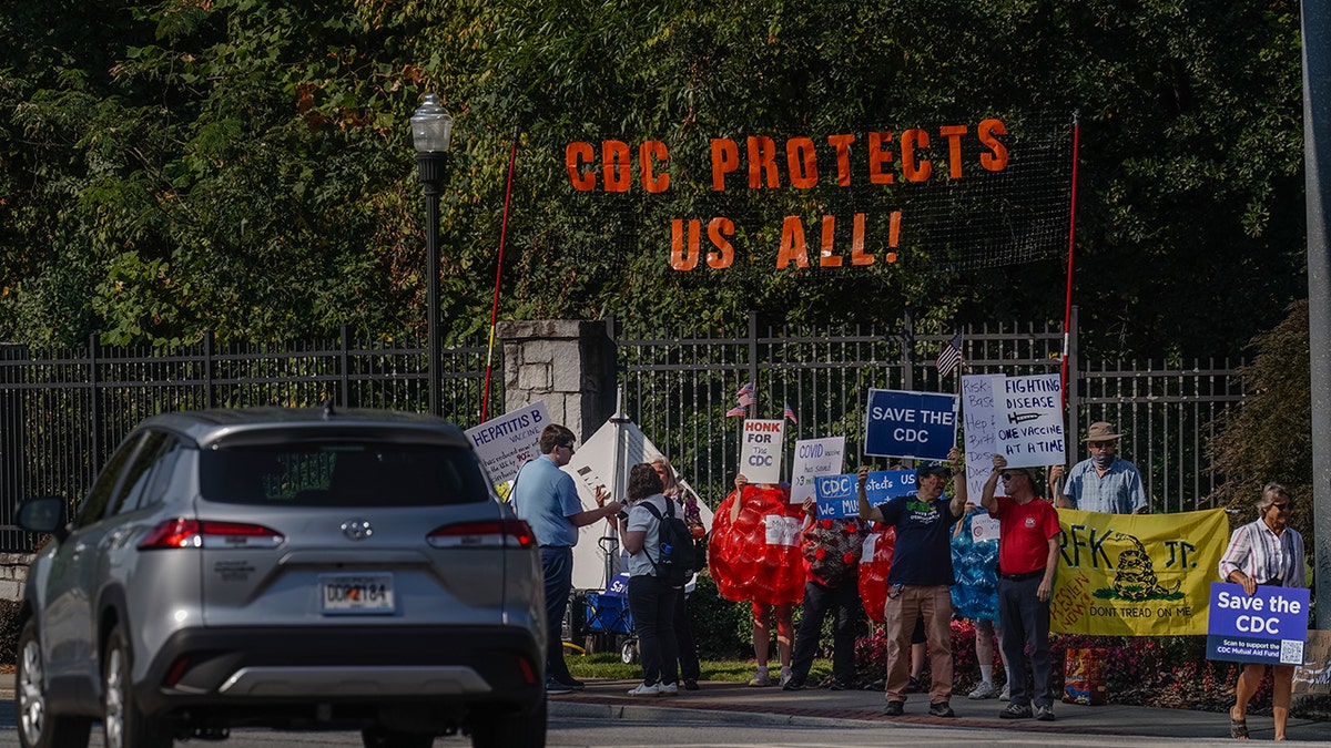 Protesters gather outside CDC headquarters in Atlanta during a meeting on COVID-19 vaccine recommendations.