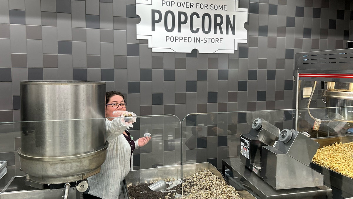 A Publix employee hands out a sample of popcorn.