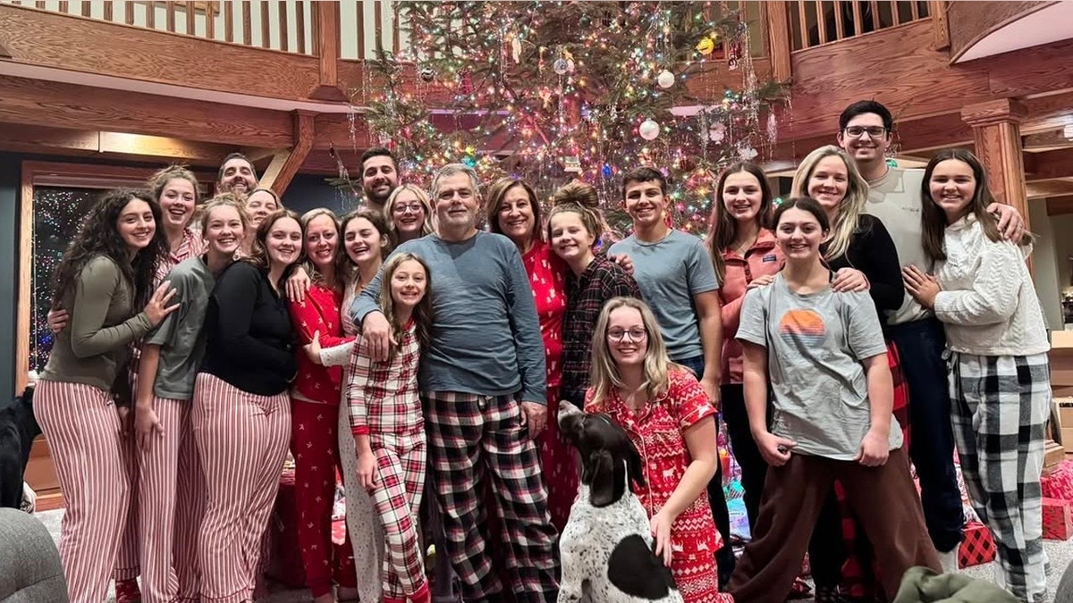 The members of the Putnam Family in front of a Christmas tree