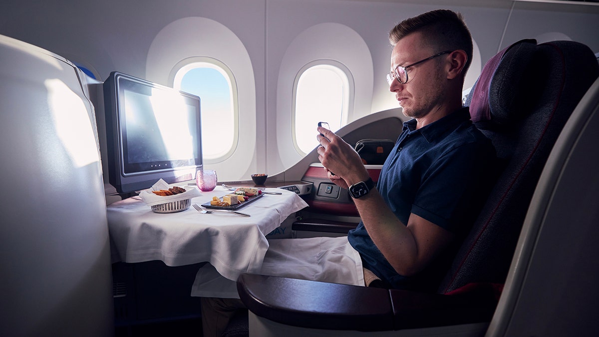 Passenger taking picture of food during flight in business class on Qatar flight