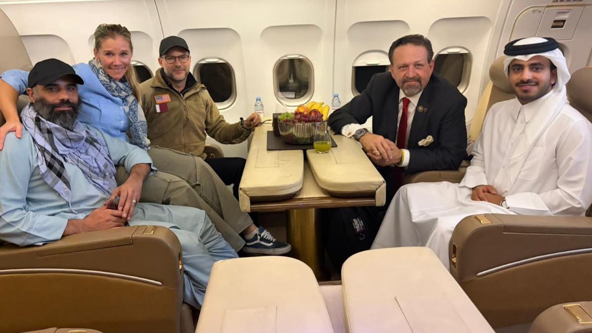 Amir Amiri and officials inside a jet