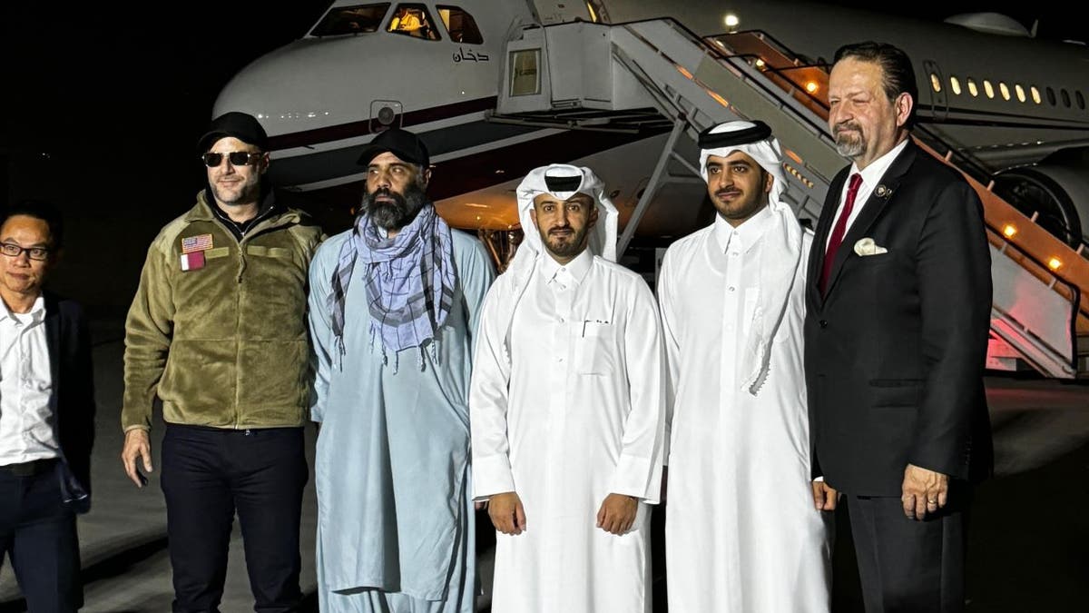 Amir Amiri standing with Qatari officials