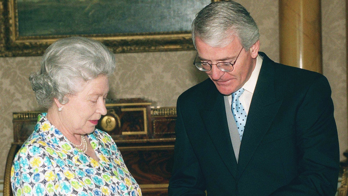 Queen Elizabeth and Sir John Major in conversation at the palace.