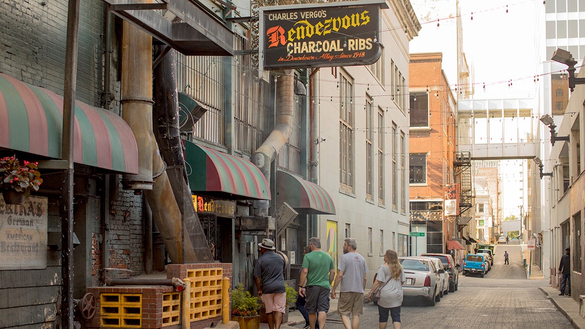 Four customers prepare to enter the Rendezvous restaurant, located in an alley in downtown Memphis.